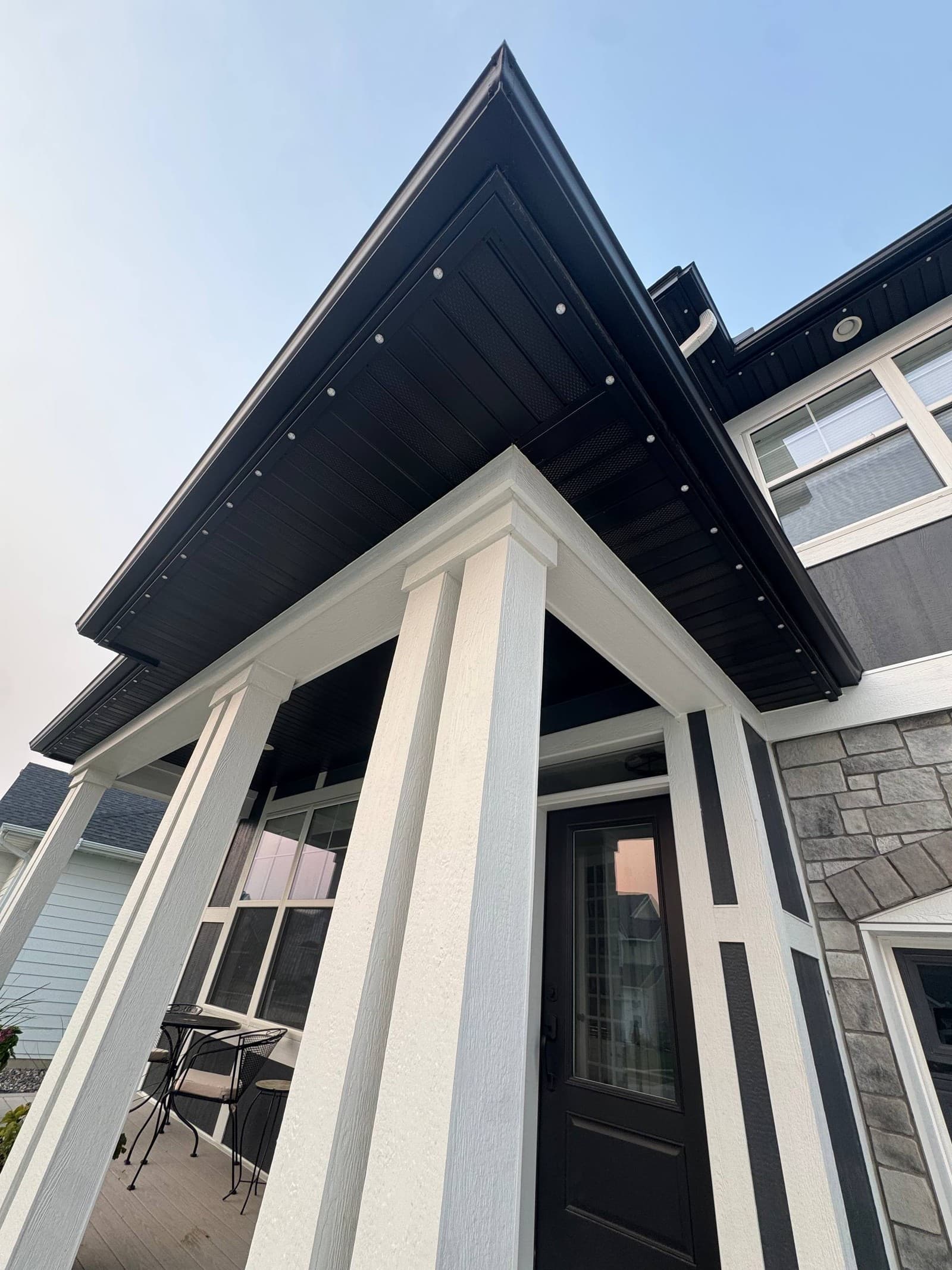 Close view of a home's black soffit with the color-matched lighting track sitting flush along the fascia